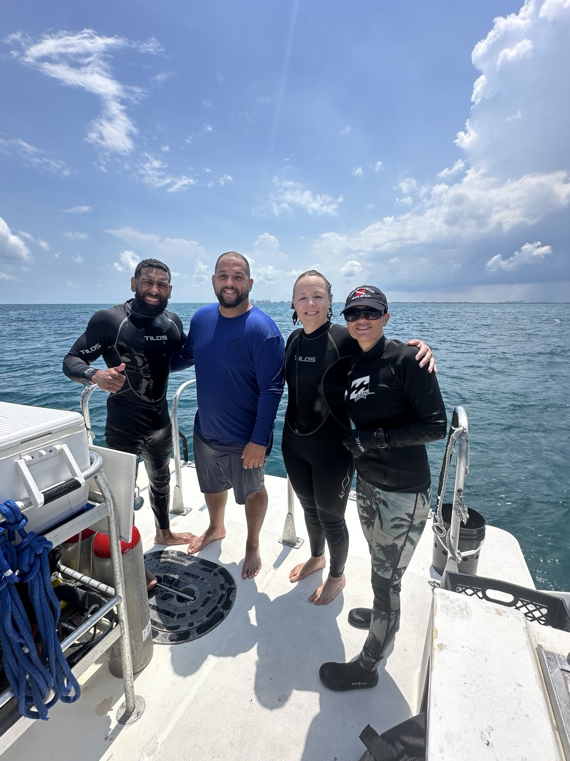 Carlos and dive crew on a boat in Cancún after a reef dive